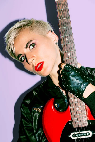 Tomboy Girl with electro guitar. Rock fashion style