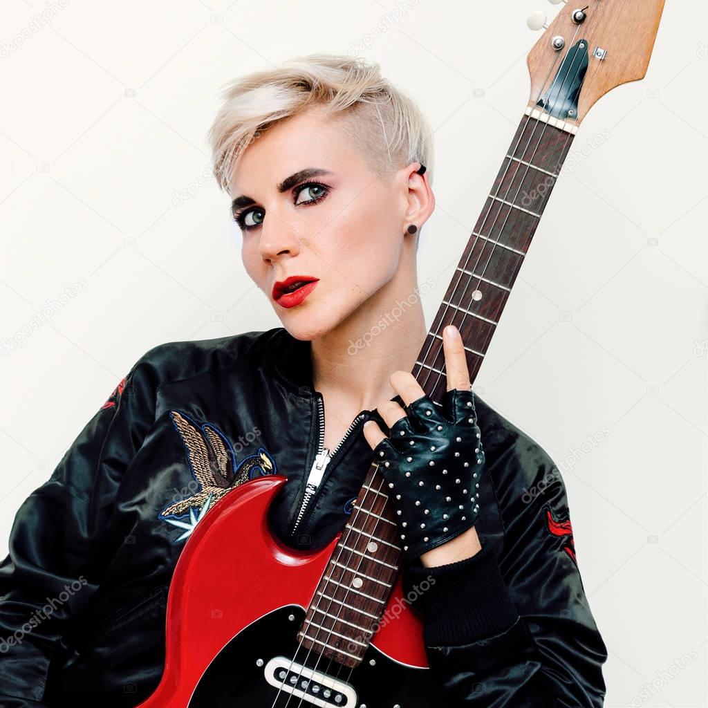Blond Model with electro guitar. Rock style fashion