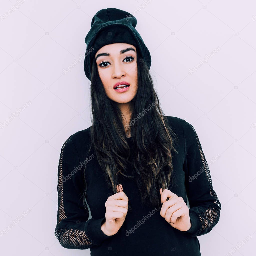 Stylish brunette in black beanie cap. Swag urban style