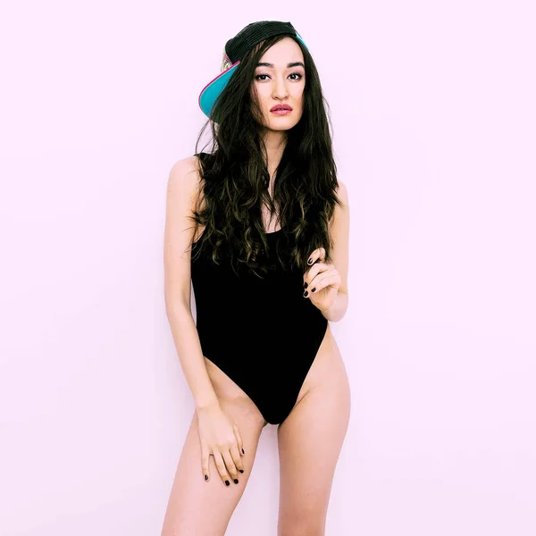Hipster teen Girl in a black swimsuit and b-boy cap — Stock Photo, Image