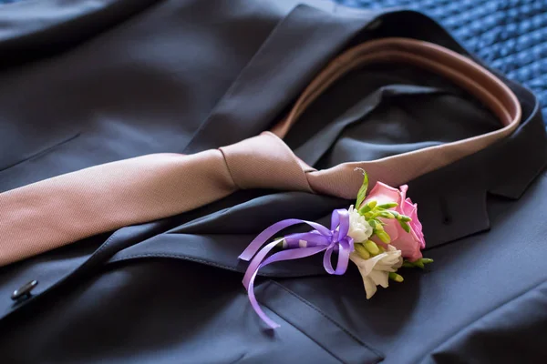 wedding bouquet and mens suit with a tie