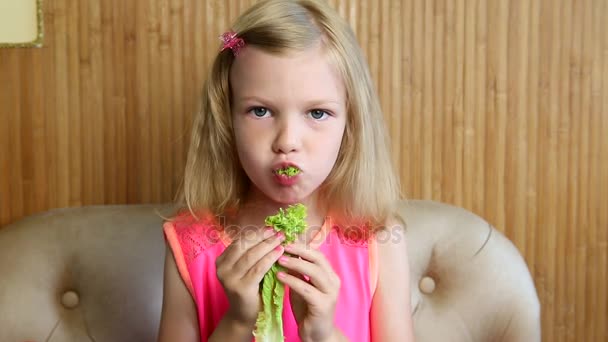 Girl eats vegetables and herbs — Stock Video