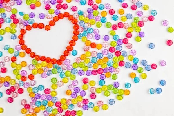 Background heart made of colored acrylic beads — Stock Photo, Image