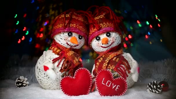 Valentines Day. lovers of snowmen are in the snow and keep the hearts of the fabric