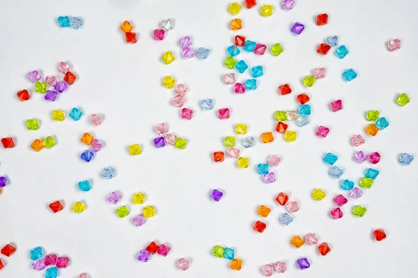 Colored beads for design on a white background