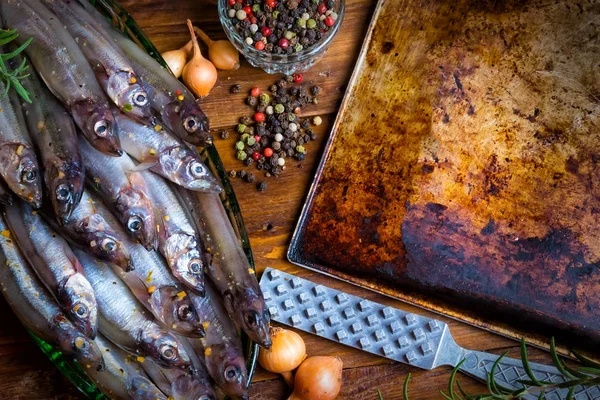 Fresh fish top view. Spicy herb and vegetables. Spice on wooden board. Healthy food cooking.