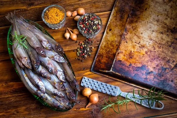 Fresh fish top view. Spicy herb and vegetables. Spice on wooden board. Healthy food cooking.