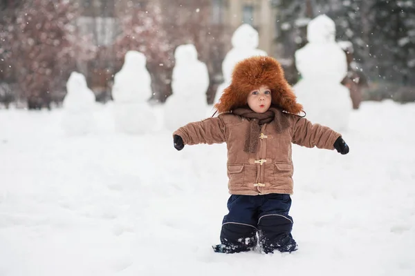 Baby for a walk in winter with a pug — Stock Photo, Image