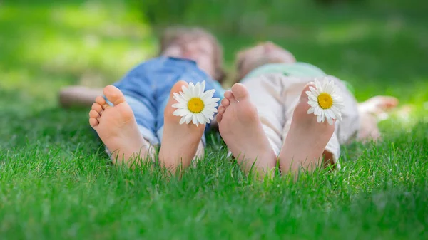 Friends lying on green grass — Stock Photo, Image
