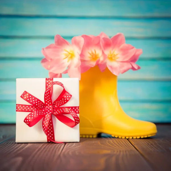 Bouquet of tulips in rain boots