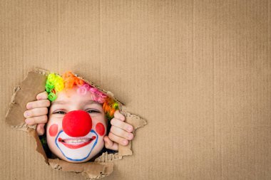 Funny kid clown playing indoor clipart