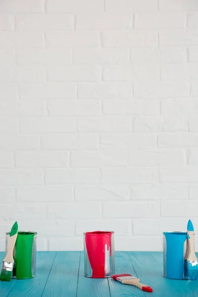 Latas de pintura sobre mesa de madera —  Fotos de Stock