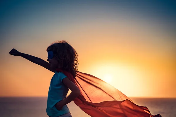 Superhero child on beach — Stock Photo, Image