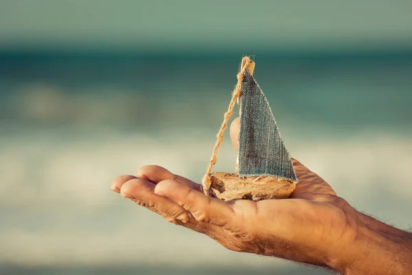 Oyuncak yelkenli tekne holding eller — Stok fotoğraf