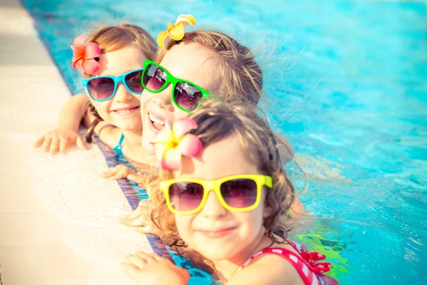 Happy children in the swimming pool — Stock Photo, Image