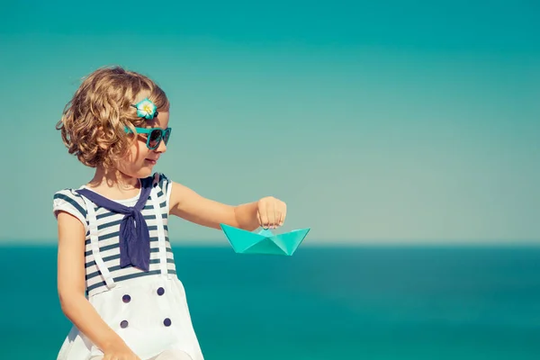 Kind mit Papiersegelboot in den Sommerferien — Stockfoto