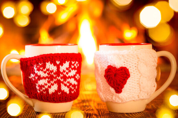 two cups in knitted covers 