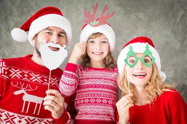 Happy family with Christmas paper props — Stock Photo, Image