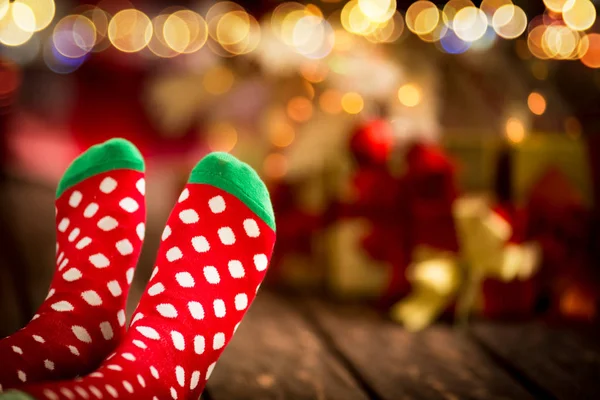 Feet in warm christmas socks — Stock Photo, Image