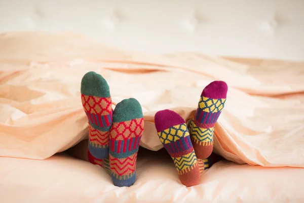 Two pairs of feet in warm socks — Stock Photo, Image