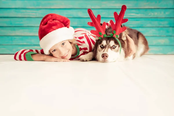 Happy child and dog on Christmas eve — Stock Photo, Image