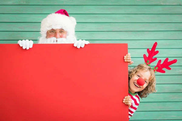 Papai Noel e criança rena — Fotografia de Stock