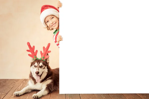 Happy child and dog on Christmas eve — Stock Photo, Image