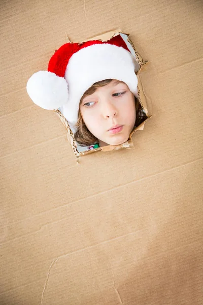 Funny kid looking through hole on cardboard — Stock Photo, Image