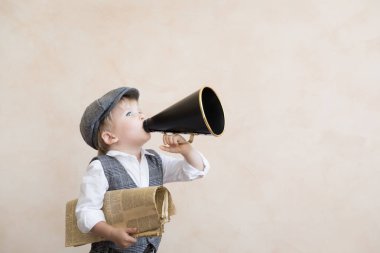 Child shouting through vintage megaphone clipart