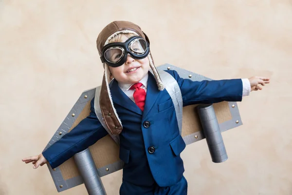 Portrait of young businessman with toy paper wings — Stock Photo, Image