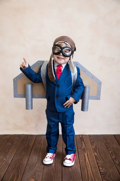 Portrait of young businessman with toy paper wings — Stock Photo, Image