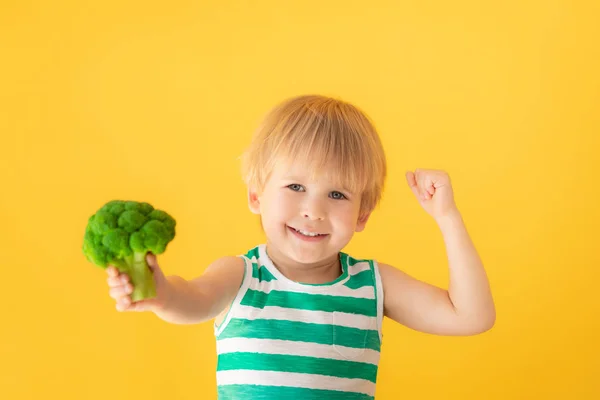 Strong child holding broccoli — Stock Photo, Image