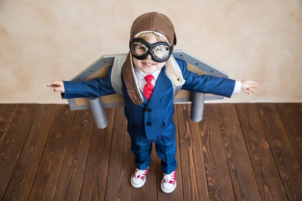 Portrait of young businessman with toy paper wings — Stock Photo, Image