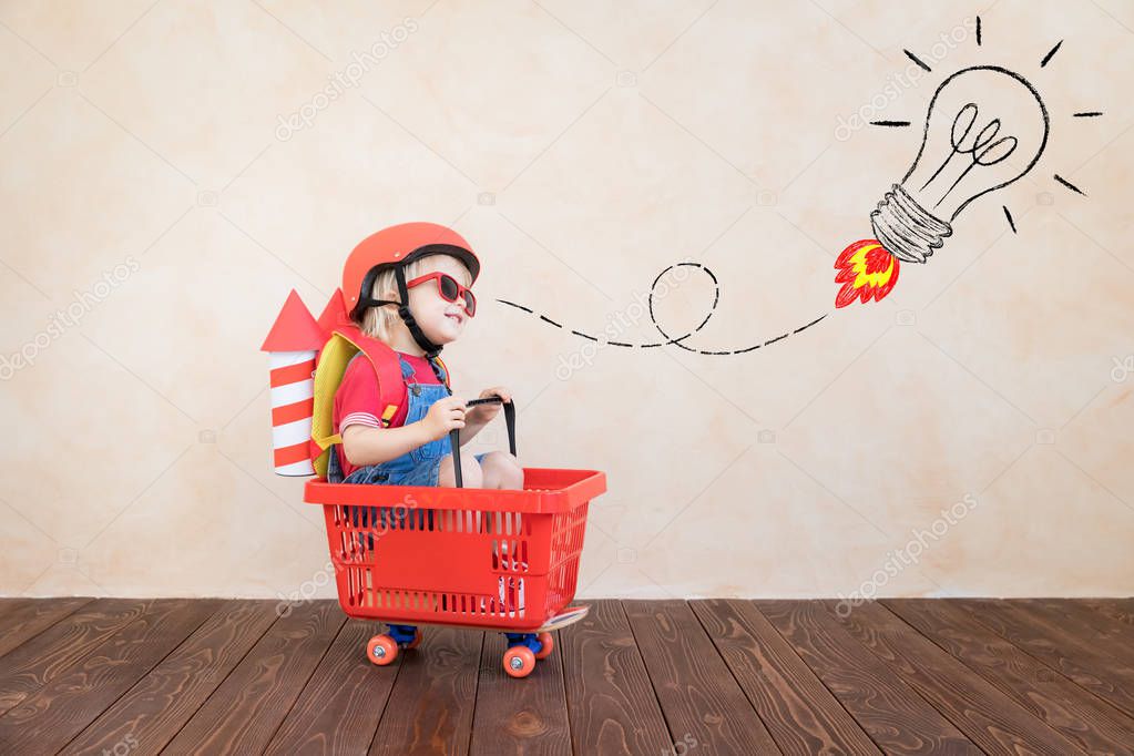 Kid playing with toy rocket at home