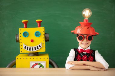 Okulda oyuncak robotu olan mutlu çocuk.