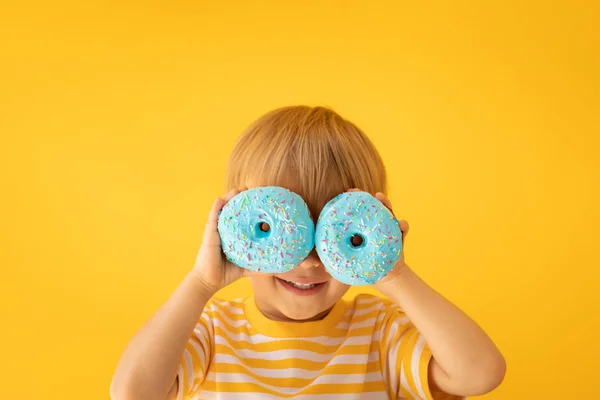 Criança feliz segurando donut envidraçado — Fotografia de Stock