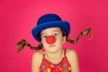 Funny girl clown playing indoor
