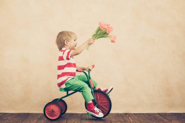 Funny child holding bouquet of flowers