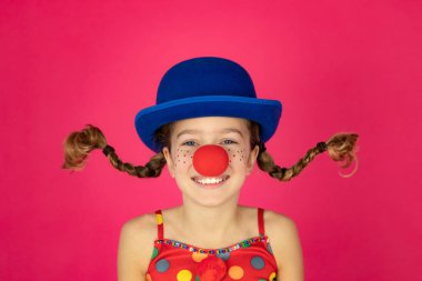 Funny girl clown playing indoor