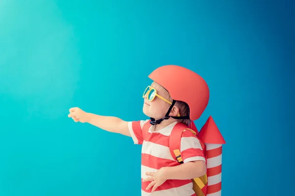 Criança Feliz Brincando Com Foguete Papel Brinquedo Contra Fundo Azul — Fotografia de Stock