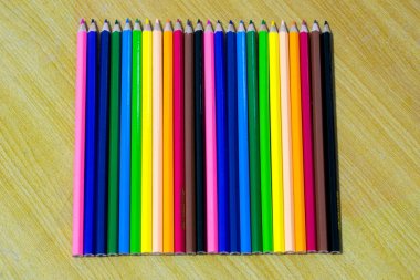 Eski ahşap tabl üzerinde renkli kalemler yakın çekim