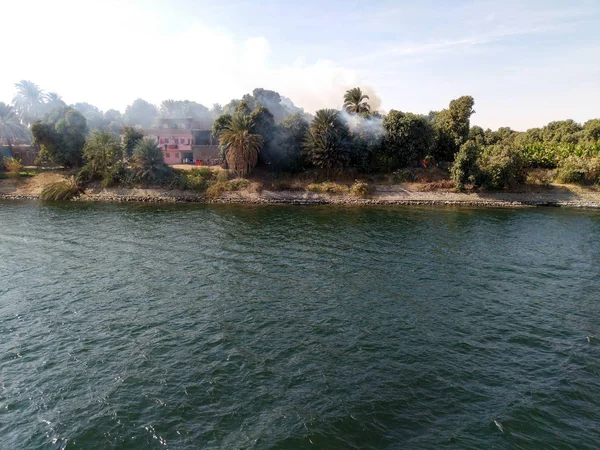 Egypt Nile cruise. Fire happened in the village. View from the river — Stock Photo, Image