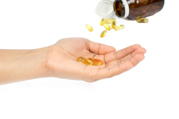 La mano de la mujer sosteniendo cápsulas de aceite de pescado con omega 3 y vitamina D concepto de dieta saludable, aislado sobre fondo blanco . — Foto de Stock