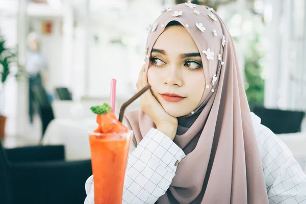 Junge schöne Muslimin mit dem Erdbeer-Smoothie im Restaurant. — Stockfoto