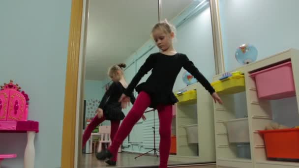 La petite fille ballerine étire les poses — Video