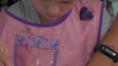 Little Girl Paints In Kindergarten