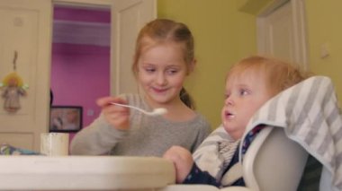 Sister Feeds Baby Boy