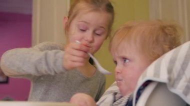 Sister Feeds Little Boy