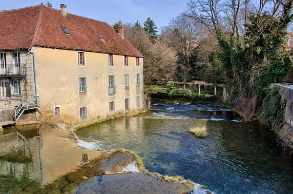 Cuisance river with old mill in Arbois Stock Photo