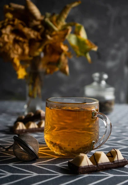 Selective focus, autumn still life. Mug of hot tea with sweets — Stock Photo, Image